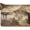 A clutch bag made from fish skin with a detailed design of a landscape.