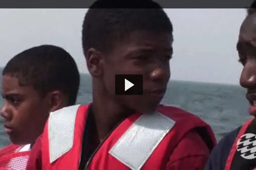 Screenshot from "Climate Change and the Chesapeake Bay" of students wearing life jackets on a boat.