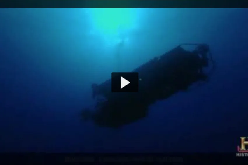 Screenshot from video "Deep Ocean Explorers" that shows view from below of submersible Alvin underwater.