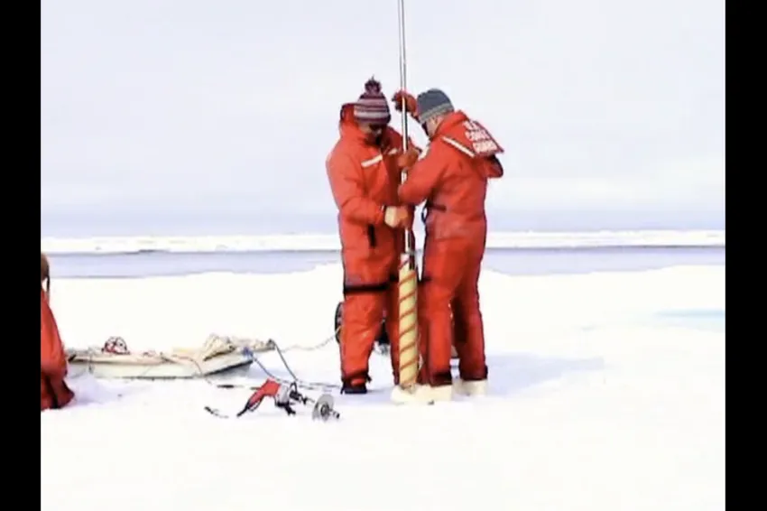 two scientists raise an ice core
