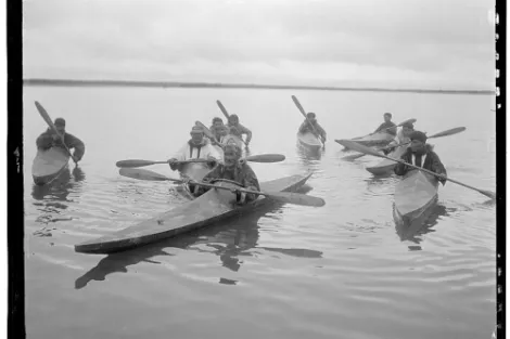 a group of men in kayaks
