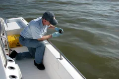 An environmental chemist collects samples of oil in the Gulf of Mexico from the Deepwater Horizon spill. The resulting chemical “fingerprint” of the oil will help determine the origin of other samples.