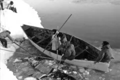 eskimos land a skin boat in the ice