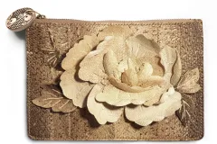 A clutch bag made from fish skin, decorated with a large flower created with collaged shapes cut from fish leather.