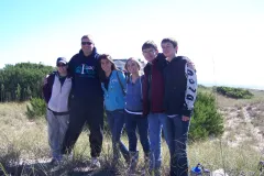 North Carolina Delegation students and teachers posing for a photo in front of the ocean at Bald Head Island in North Carolina