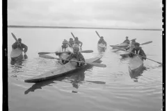 a group of men in kayaks