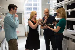 Leftwich (second from left) and her colleagues examine a robotic sea lion flipper, which is used to replicate and study the motions of a real sea lion flipper.