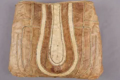 A brown fish skin bag with stitched, organic designs.