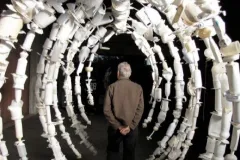 A whalebone rib cage replica made from empty white bottles. 