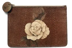A brown clutch bag made from fish skin with a beige flower in the center, patterned with wood grain.