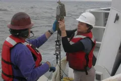 Research Zoologist, Karen Osborn on a ship at sea, working to release a line
