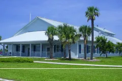 A gabled building alongside palm trees