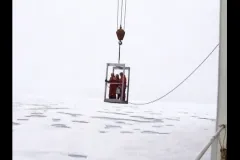 scientists are being lowered onto the ice from the ship