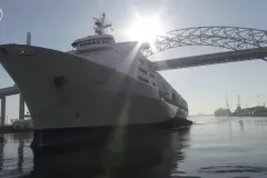 a large ship under a bridge