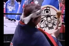 a woman beating a drum