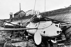a metal submarine in a wooden dry dock