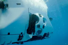 an underwater view of a white submersible