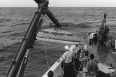 an autonomous robot is lowered over the side of a ship