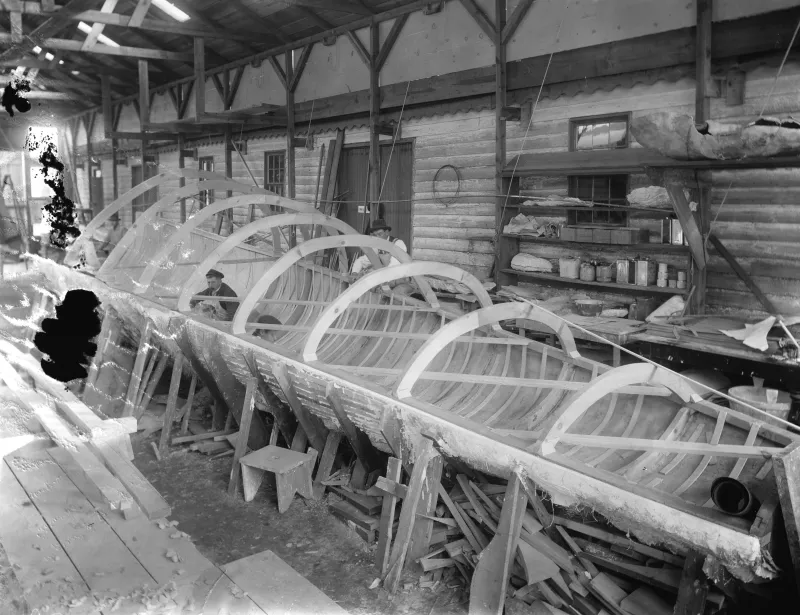 a worker sits inside the cast of a whale