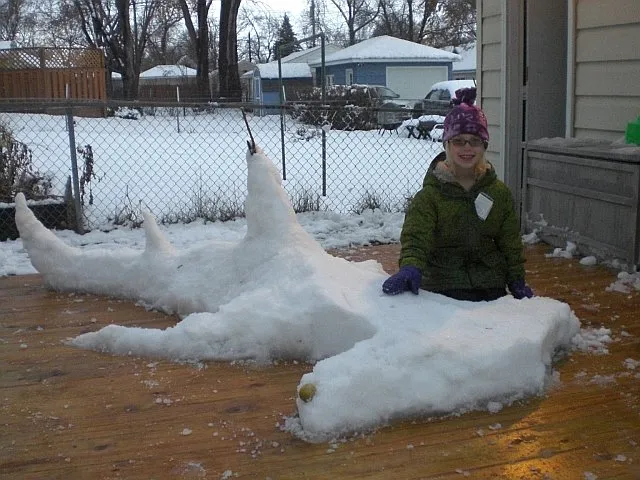 Sophi Bromenshenkel poses with a hammerhead shark snow sculpture.