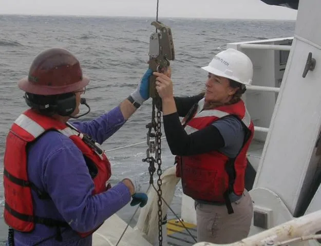 Research Zoologist, Karen Osborn on a ship at sea, working to release a line