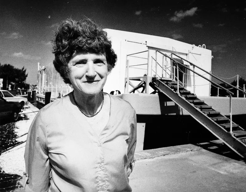 A woman standing in front of a barge 
