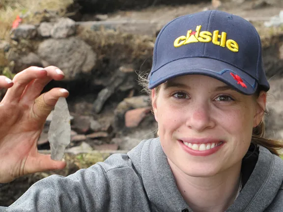 A researcher holds a maritime archaic point made of ramah chert that was found at Hare Harbor in Quebec, Canada in 2011