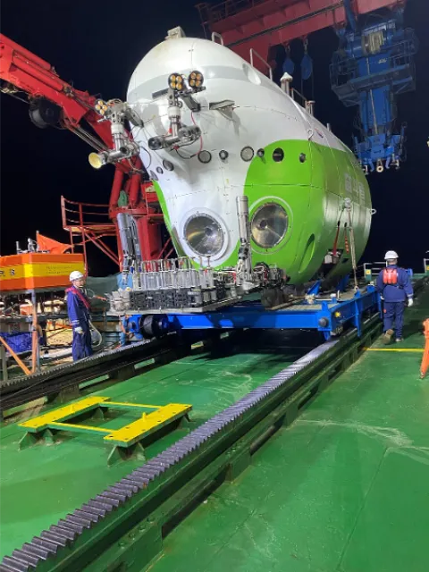 a white and lime green sub in the hull of a ship